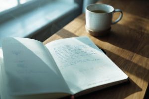 Open journal with cup